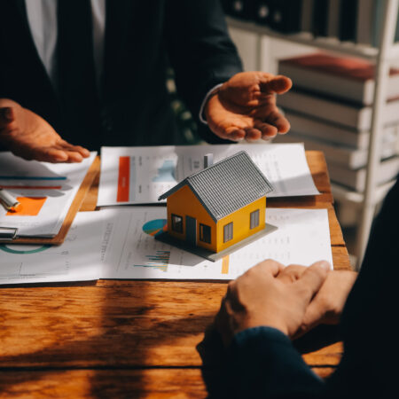 Real estate agent and customer signing contract to buy house, in Real estate agent and customer signing contract to buy house, insurance or loan real estate.rent a house,get insurance or loan real estate or property.